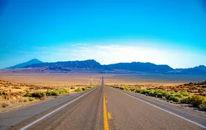 Nevada highway and mountain landscape representing a change of trust situs
