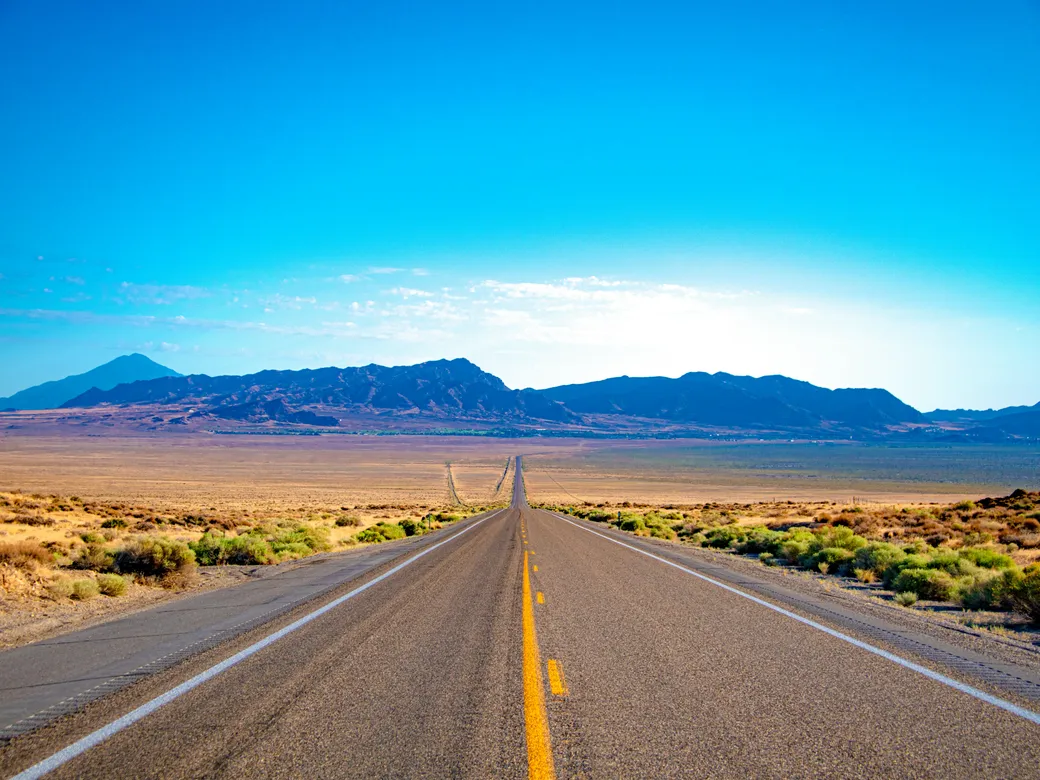 Nevada highway and mountain landscape representing a change of trust situs