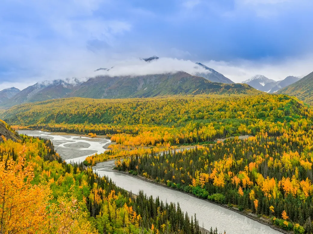 Alaska mountain valley and river representing a Nevada and Alaska trust comparison