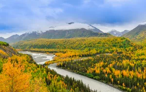Alaska mountain valley and river representing a Nevada and Alaska trust comparison
