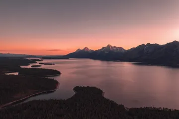 Wyoming mountain lake at sunset representing a Nevada and Wyoming trust comparison