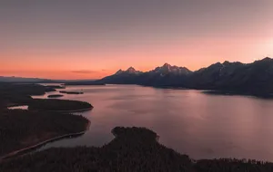 Wyoming mountain lake at sunset representing a Nevada and Wyoming trust comparison