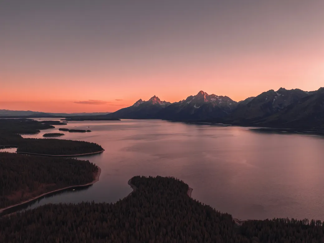 Wyoming mountain lake at sunset representing a Nevada and Wyoming trust comparison