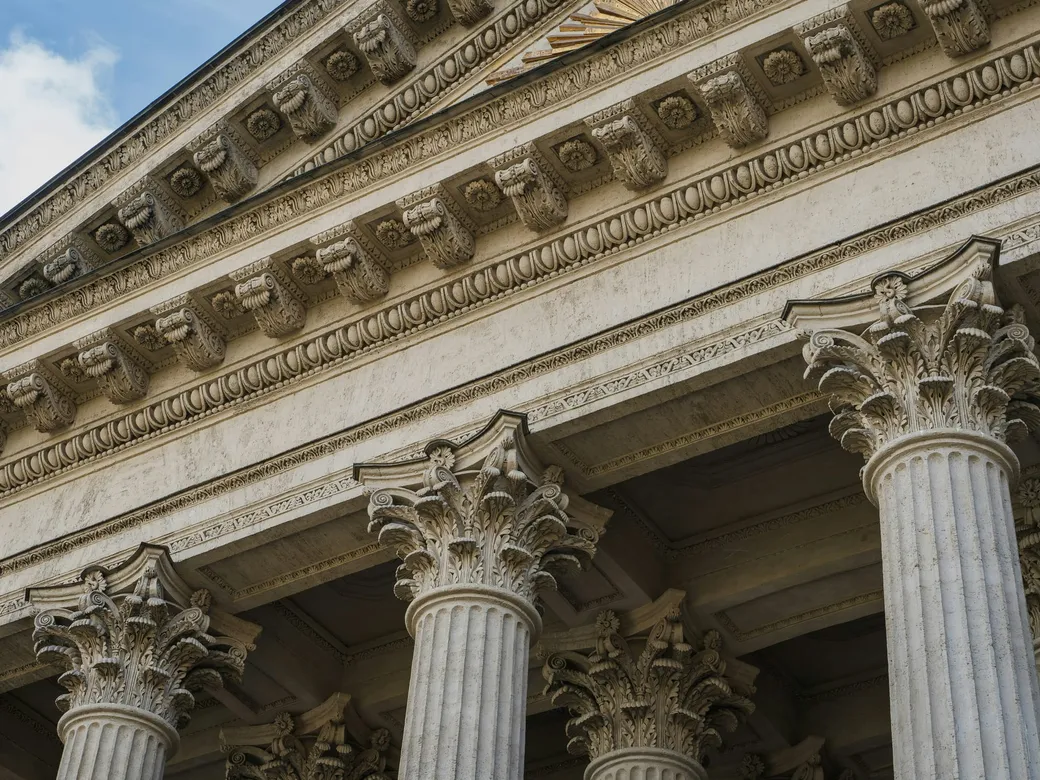 Classical stone columns representing the transfer of an existing trust into updated terms