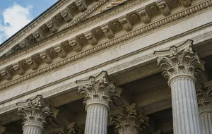 Classical stone columns representing the transfer of an existing trust into updated terms